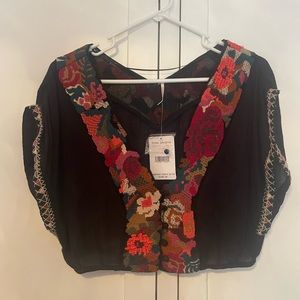 Black boho inspired crop top with detailed embroidery.